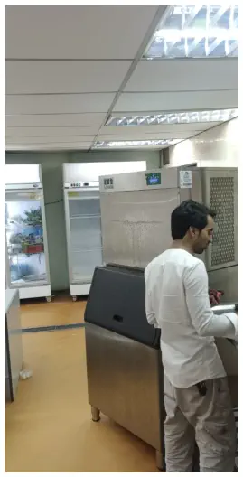 Technician servicing commercial refrigeration equipment